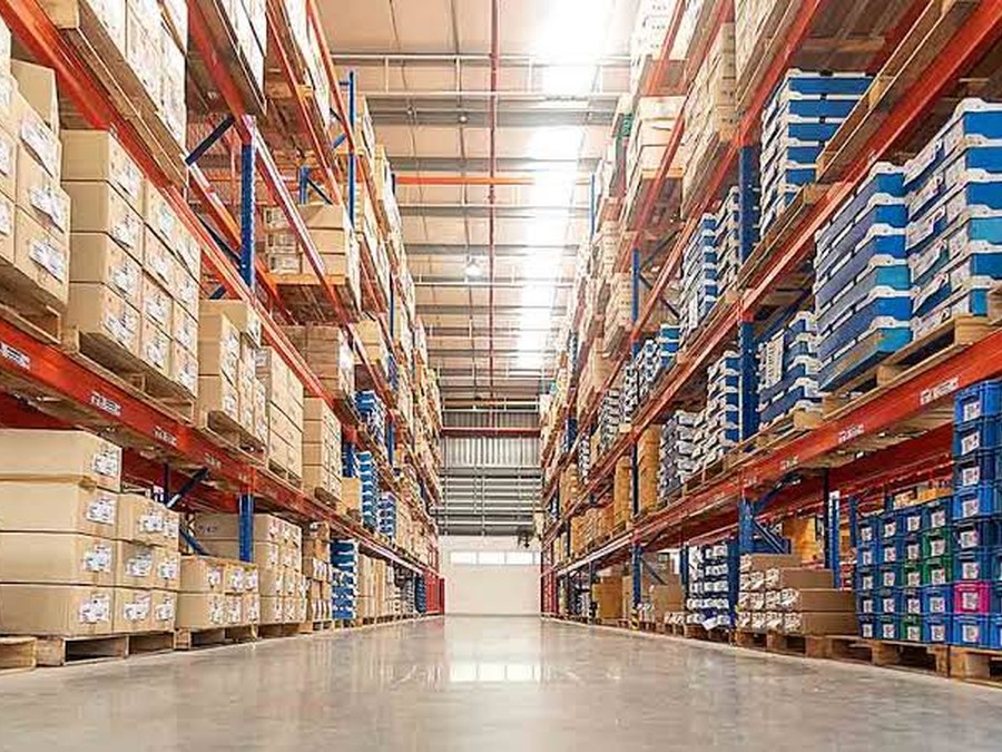 Rows of organized warehouse shelving stocked with pallets